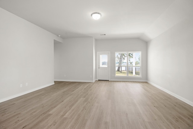 unfurnished living room featuring light hardwood / wood-style floors and lofted ceiling