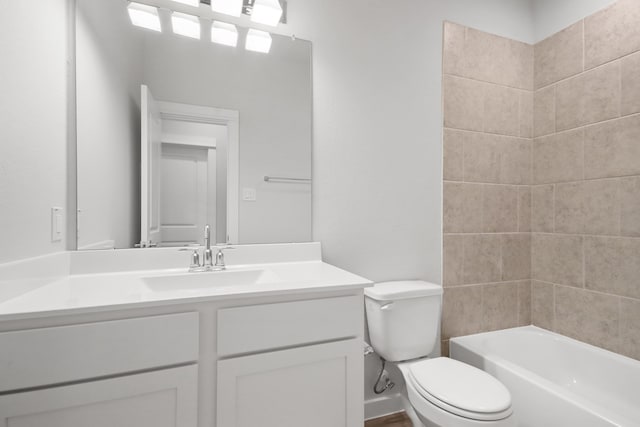 full bathroom featuring vanity, toilet, and tiled shower / bath