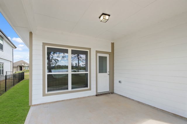 property entrance with a patio and a yard