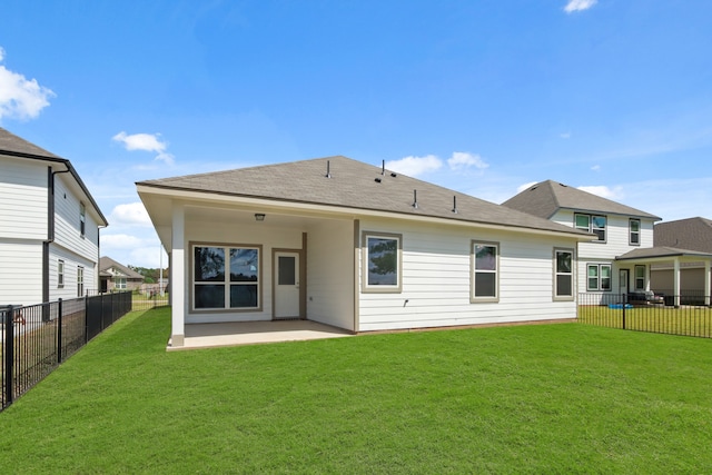 back of house with a lawn and a patio area