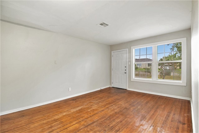 unfurnished room featuring dark wood-type flooring