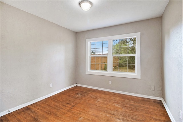 empty room with hardwood / wood-style flooring