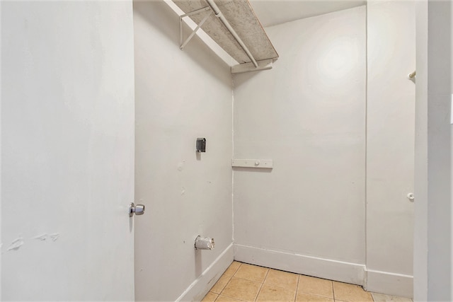 clothes washing area with light tile patterned floors and electric dryer hookup