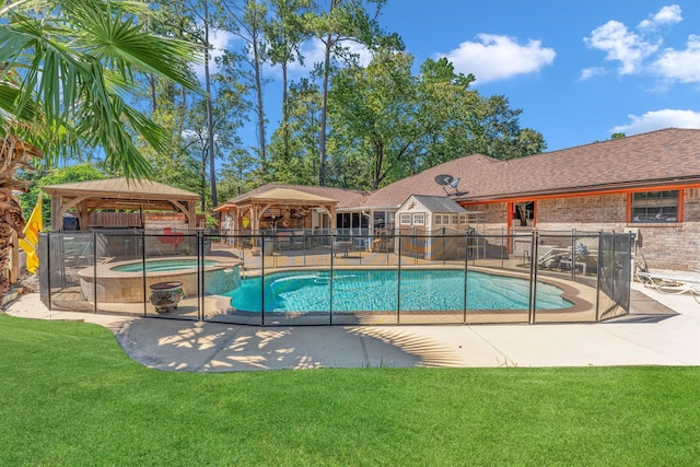 view of swimming pool with a yard, a patio, a gazebo, and an in ground hot tub