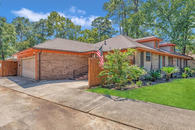 view of front of home with a front yard and a garage