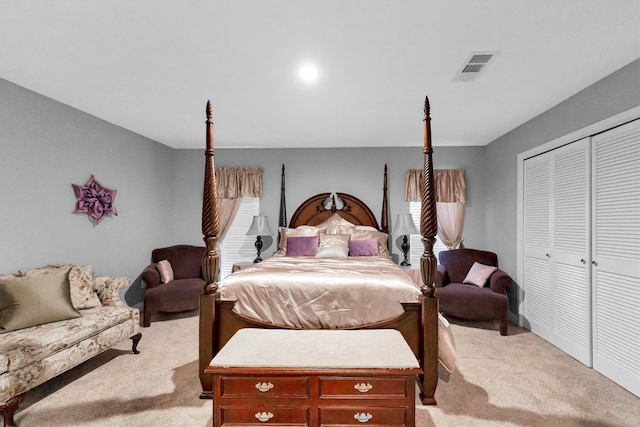 bedroom with a closet and light carpet