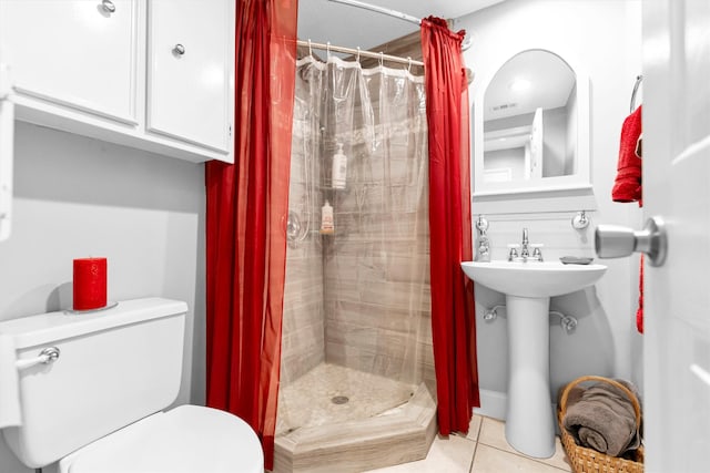 bathroom featuring a shower with shower curtain, tile patterned flooring, and toilet