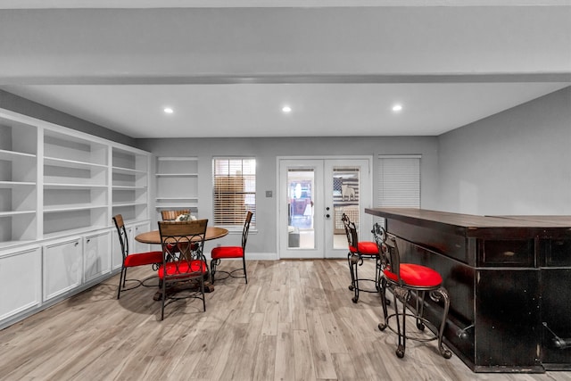 dining space featuring light wood-type flooring and french doors