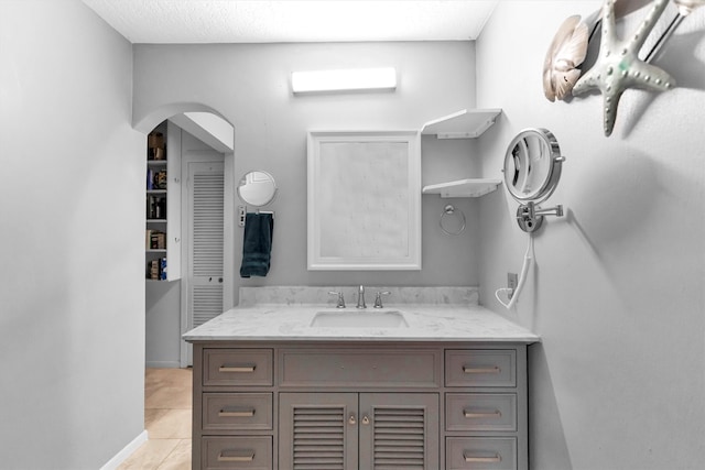 bathroom featuring tile patterned flooring and vanity