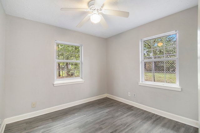 unfurnished room with ceiling fan and dark hardwood / wood-style floors