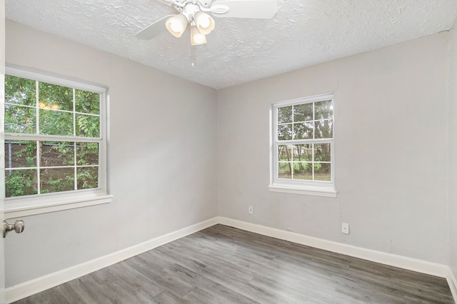 unfurnished room featuring ceiling fan, dark hardwood / wood-style flooring, and a textured ceiling