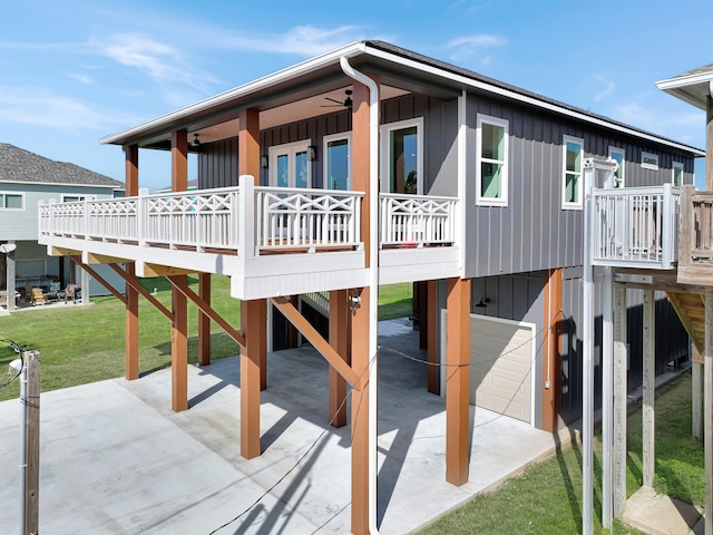 view of play area featuring a garage, a yard, and a patio area