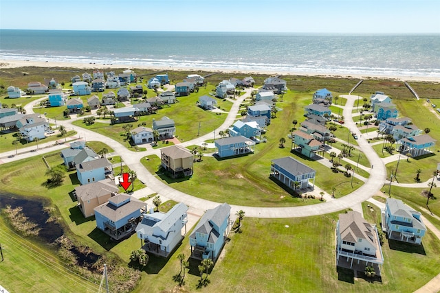 drone / aerial view featuring a view of the beach and a water view