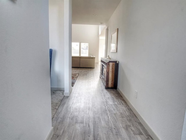 hallway with light hardwood / wood-style floors