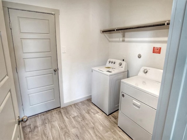 laundry room with light wood-type flooring and independent washer and dryer