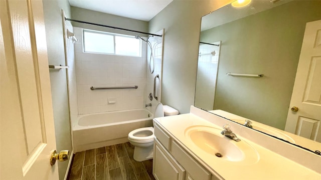 full bathroom with tiled shower / bath, vanity, toilet, and wood-type flooring