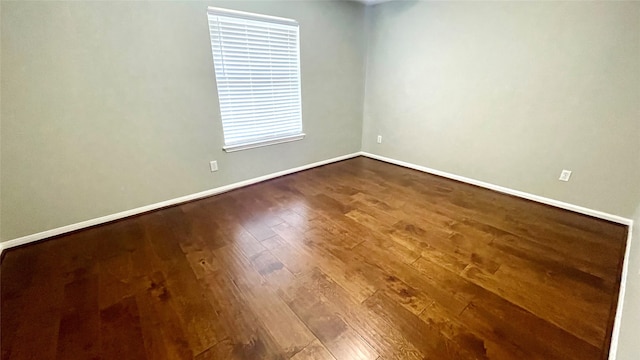 unfurnished room with wood-type flooring