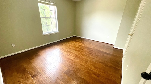 spare room with hardwood / wood-style floors