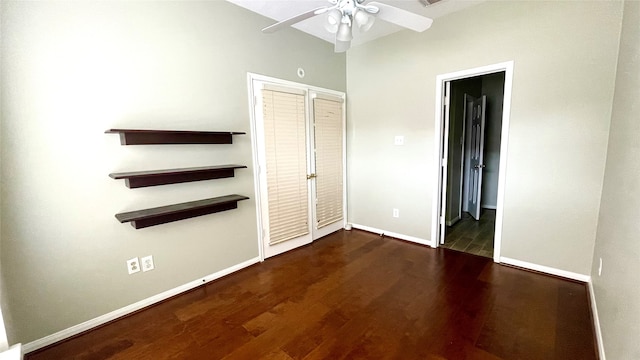 unfurnished bedroom featuring dark hardwood / wood-style flooring, ceiling fan, and a closet