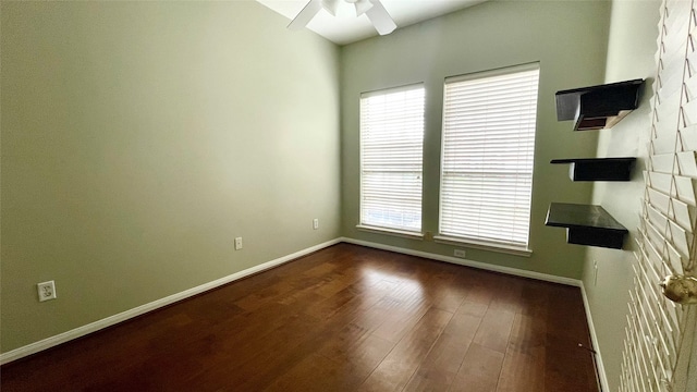 unfurnished room with ceiling fan, dark hardwood / wood-style flooring, and a healthy amount of sunlight