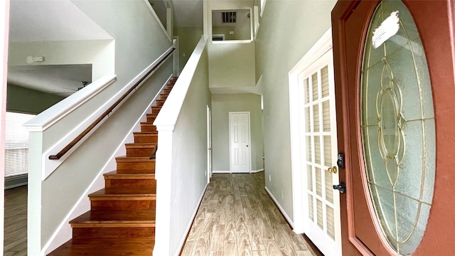 stairs featuring hardwood / wood-style flooring