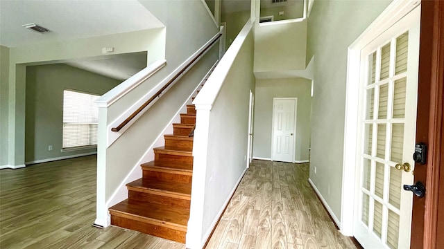 staircase featuring wood-type flooring