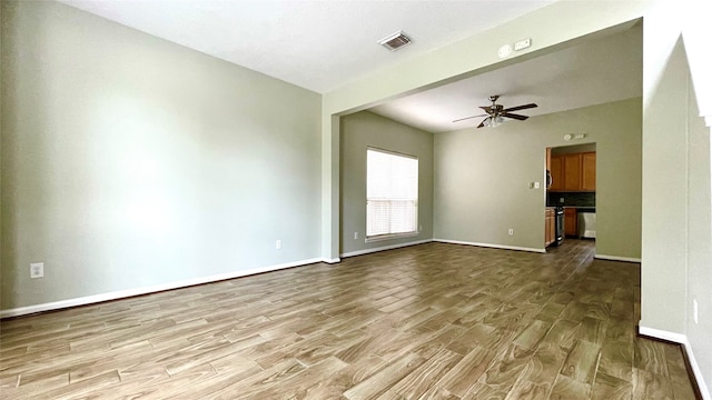 unfurnished living room with light wood-type flooring and ceiling fan