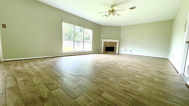 unfurnished living room featuring a fireplace, light wood-type flooring, and ceiling fan