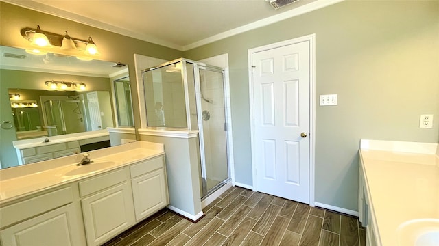 bathroom with crown molding, vanity, hardwood / wood-style flooring, and a shower with door