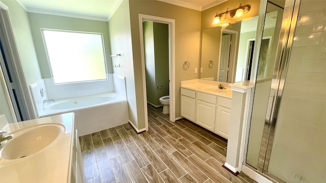 full bathroom featuring vanity, toilet, ornamental molding, and shower with separate bathtub