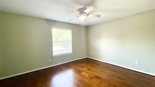 unfurnished room featuring dark wood-type flooring, a textured ceiling, and ceiling fan