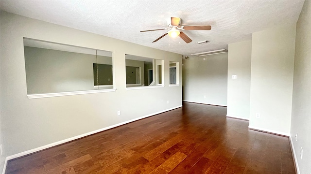 spare room featuring ceiling fan, dark hardwood / wood-style flooring, and a textured ceiling