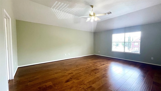 unfurnished room with vaulted ceiling, dark hardwood / wood-style flooring, and ceiling fan