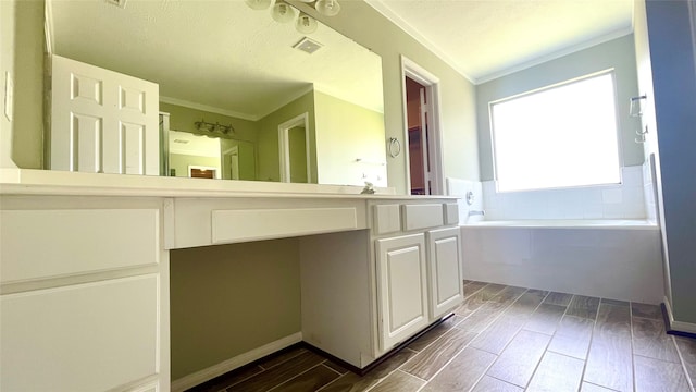 bathroom featuring ornamental molding, vanity, a bath, and hardwood / wood-style floors