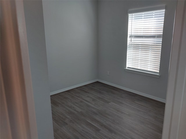 empty room featuring dark hardwood / wood-style flooring