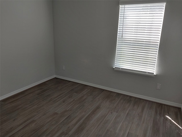 empty room featuring dark hardwood / wood-style flooring