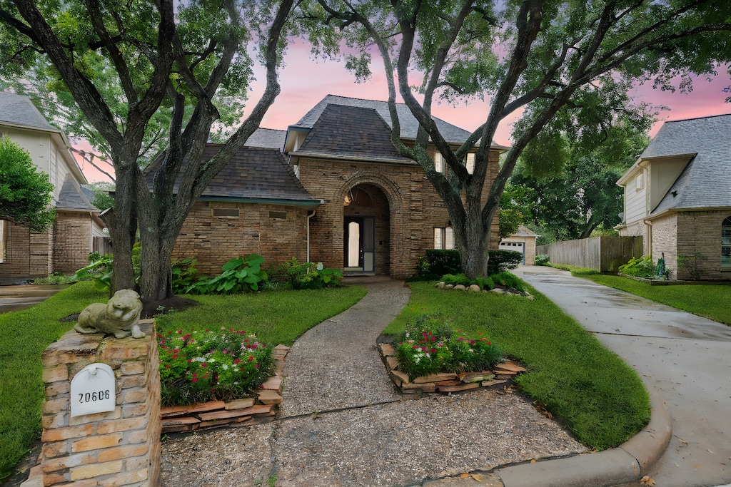 view of front of property with a yard and a garage