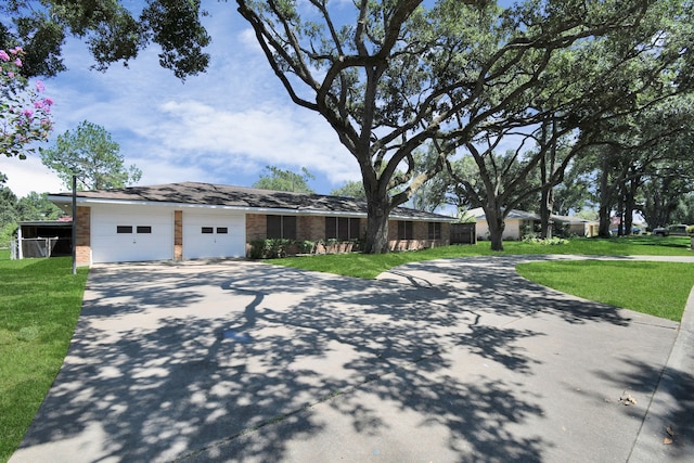 ranch-style house with a garage and a front yard