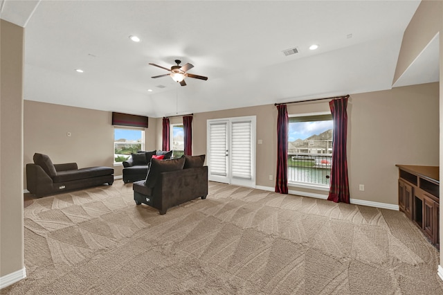 living room with light colored carpet and ceiling fan