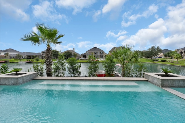 view of pool with pool water feature and a water view