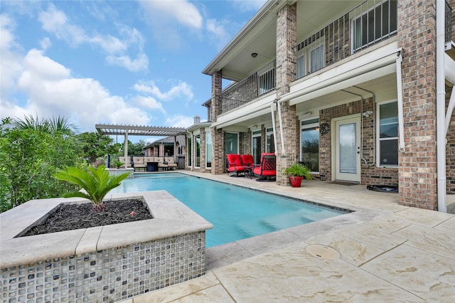 view of pool with a pergola, an outdoor fire pit, and a patio area