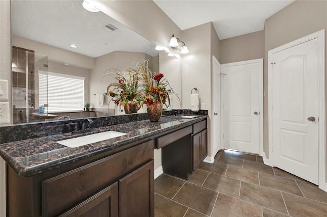 bathroom featuring vanity, tile patterned floors, and a shower with door