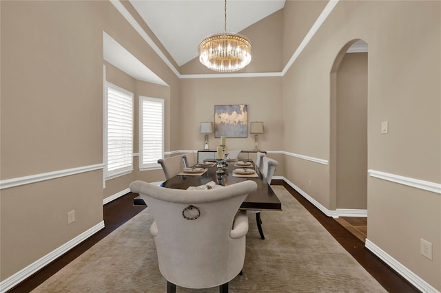 sitting room with dark hardwood / wood-style floors, high vaulted ceiling, and an inviting chandelier