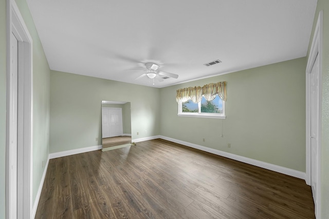 spare room with dark hardwood / wood-style floors and ceiling fan