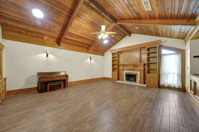 unfurnished living room with a brick fireplace, ceiling fan, wood-type flooring, lofted ceiling with beams, and wooden ceiling