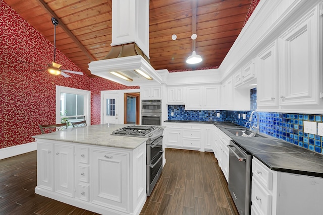 kitchen with sink, decorative light fixtures, a kitchen island, white cabinetry, and stainless steel appliances