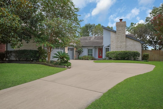 view of front of property with a front lawn and a garage