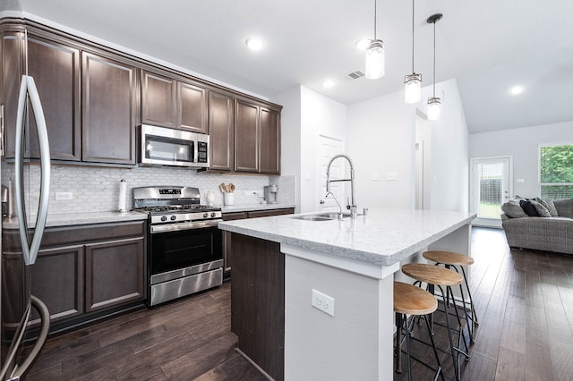 kitchen featuring decorative light fixtures, stainless steel appliances, dark hardwood / wood-style flooring, and sink