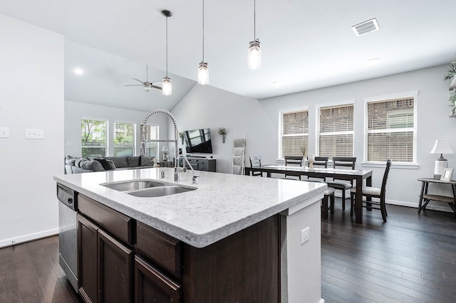 kitchen featuring a kitchen island with sink, vaulted ceiling, sink, ceiling fan, and dark wood-type flooring