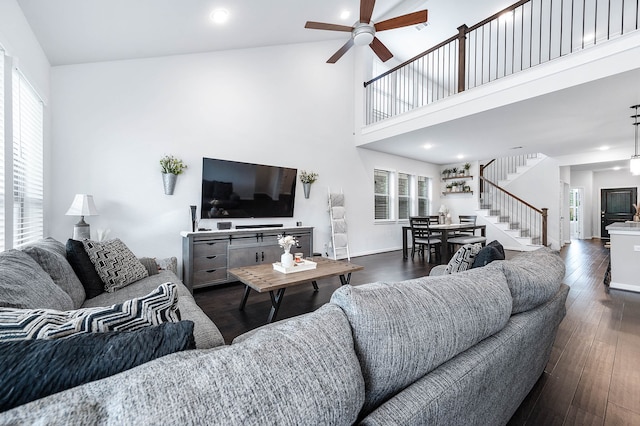 living room with high vaulted ceiling, ceiling fan, a wealth of natural light, and dark hardwood / wood-style flooring